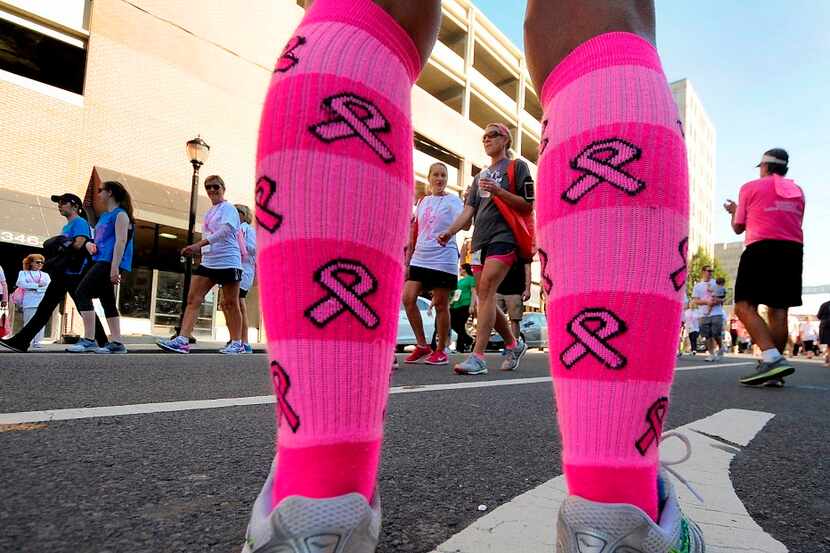 Runner Alicen Cheshire sports a pair of bright pink socks during the 25th Annual Susan G....