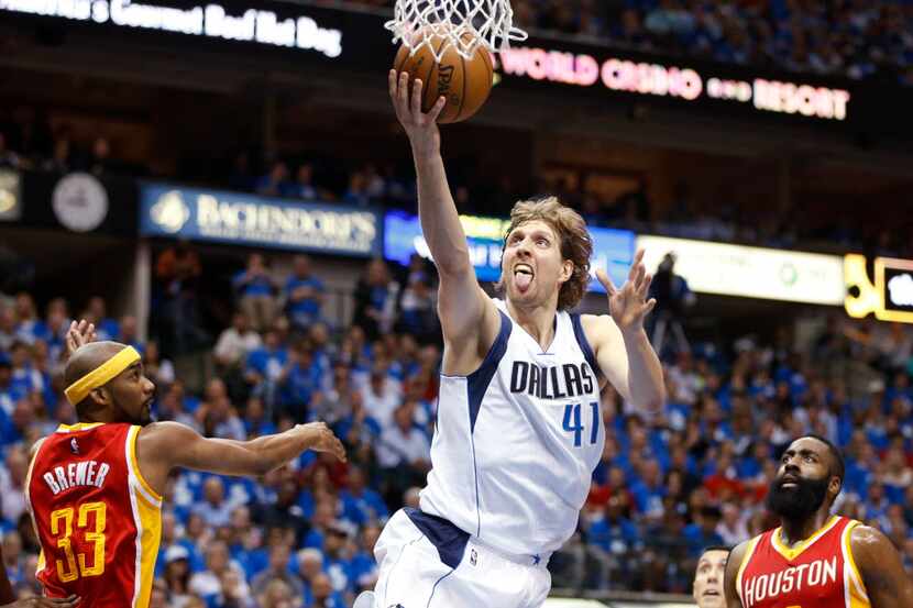 Dallas Mavericks forward Dirk Nowitzki (41) shoots  a layup in between Houston Rockets guard...