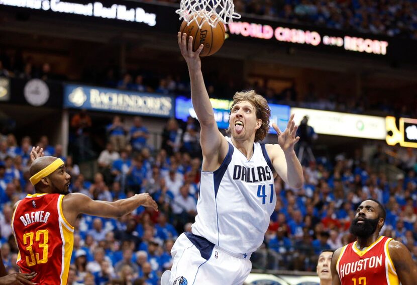 Dallas Mavericks forward Dirk Nowitzki (41) shoots  a layup in between Houston Rockets guard...