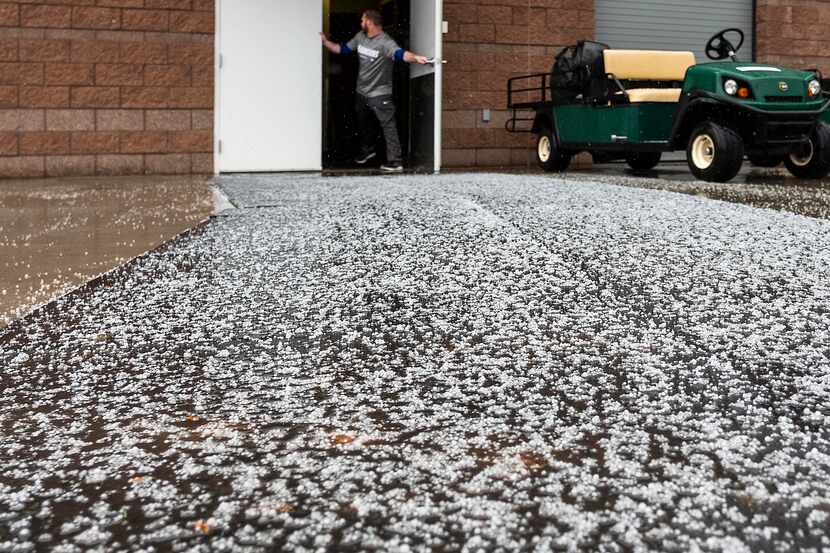 Snow pellets collect outside the Texas Rangers clubhouse door during a winter storm that hit...