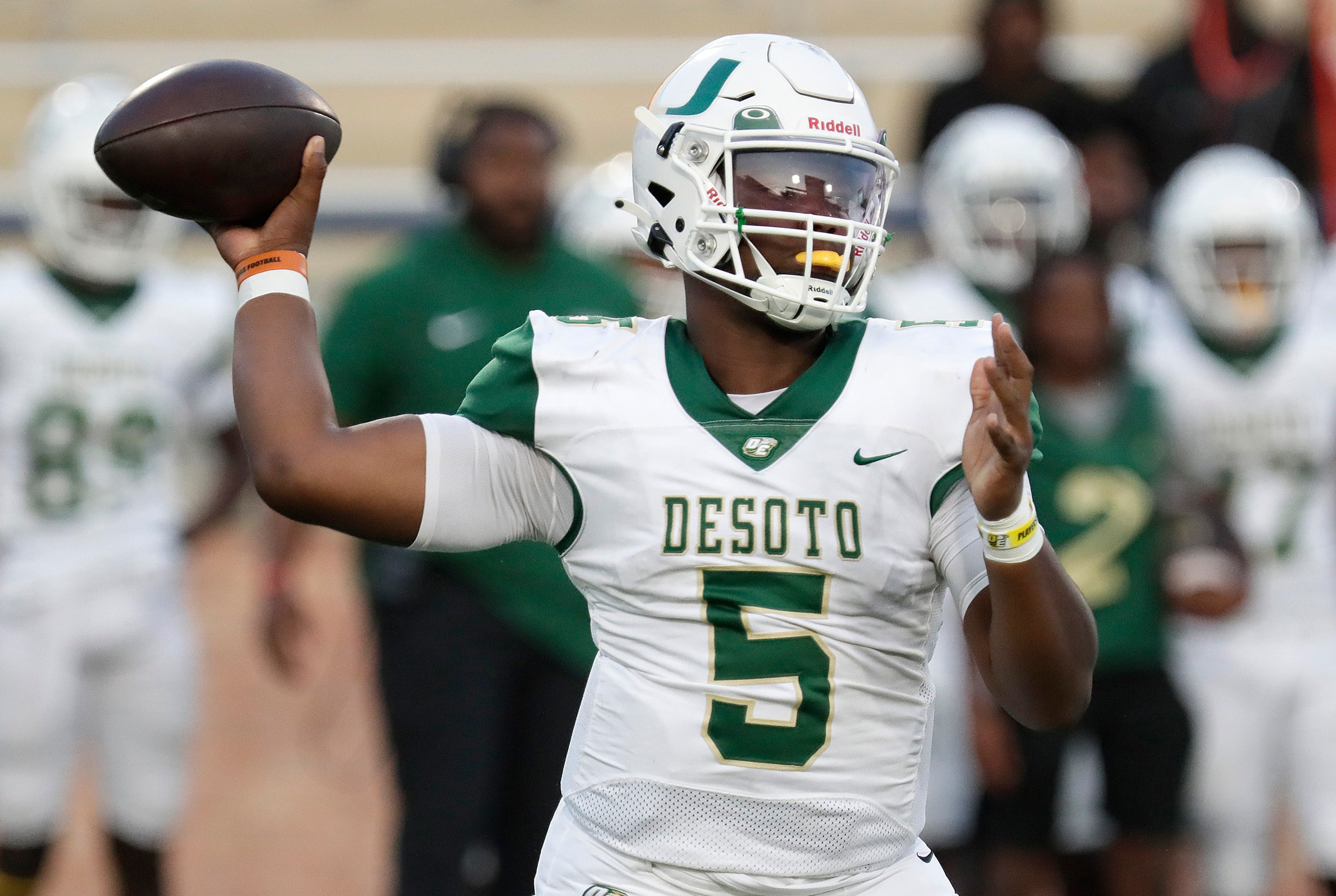 DeSoto High School quarterback Darius Bailey (5) throws a pass during the first half as...