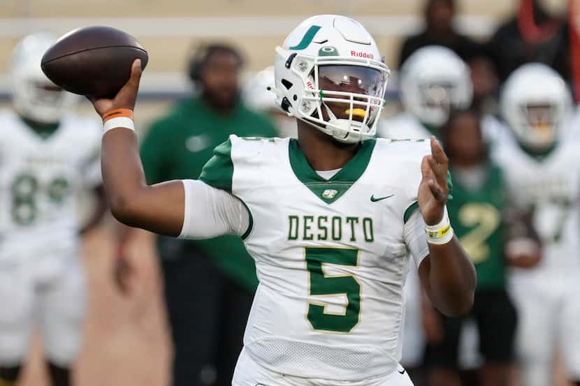 DeSoto High School quarterback Darius Bailey (5) throws a pass during the first half as...