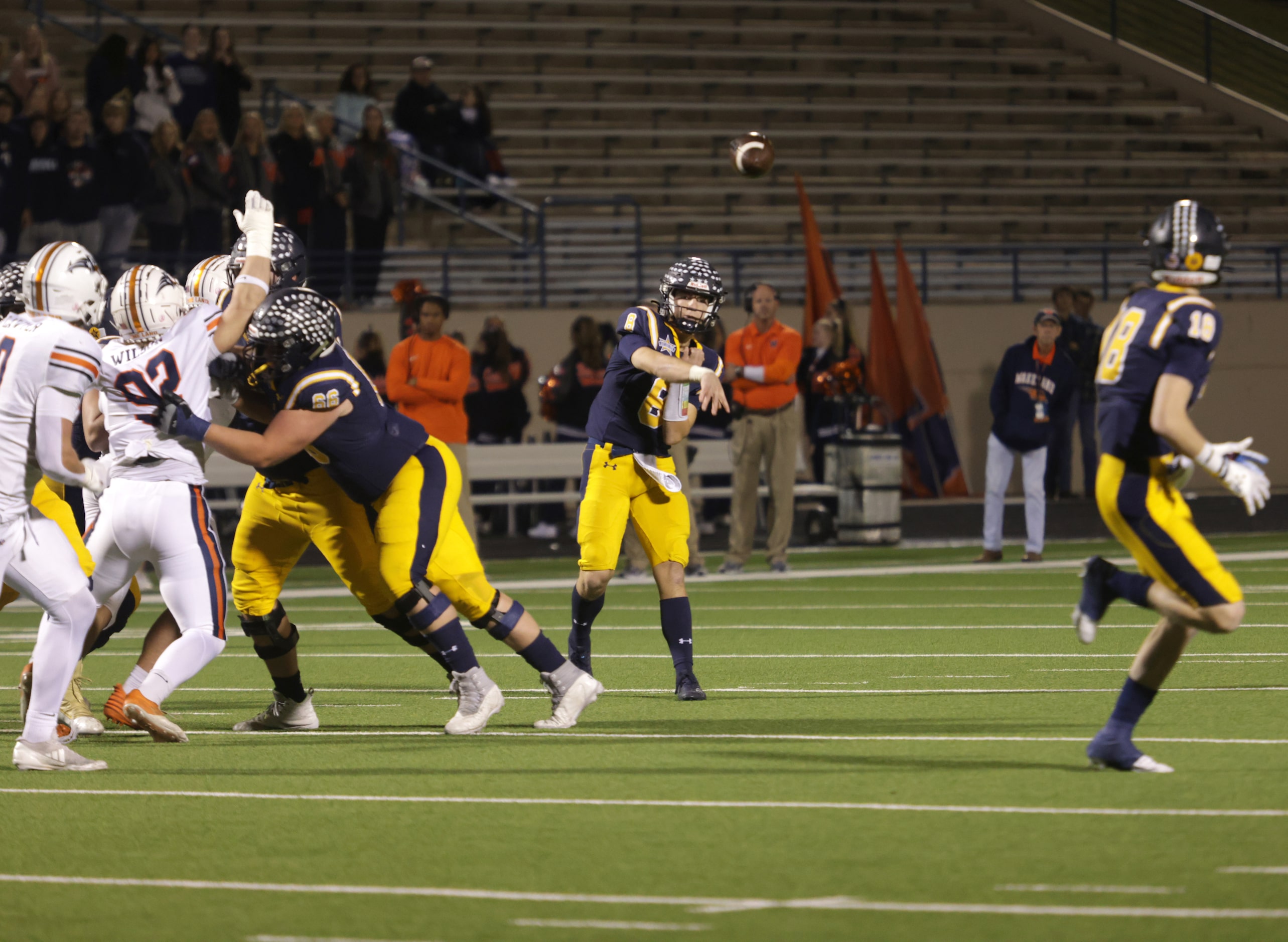 Highland Park's Buck Randall throws a pass to Brandon Lilly (No. 18) in a high school...