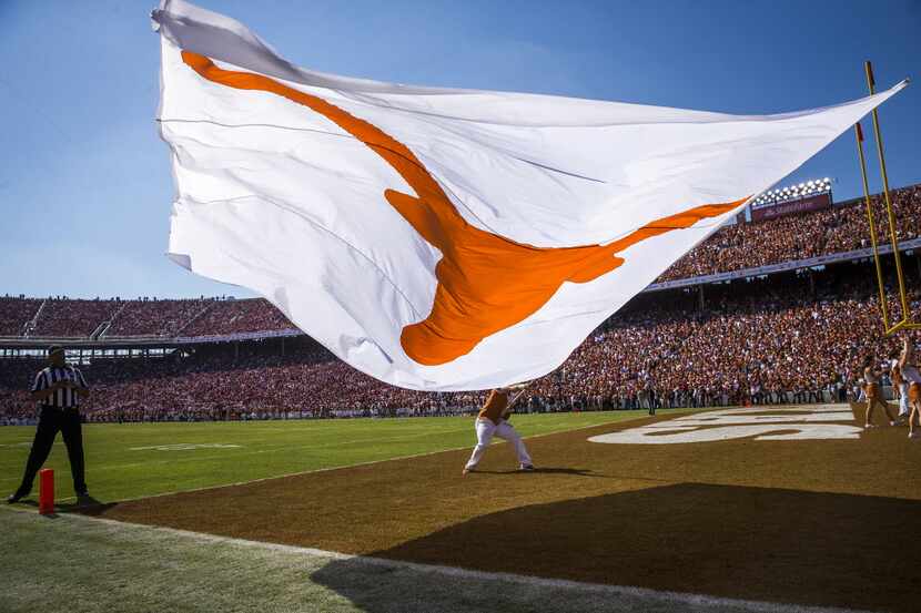 A Longhorn flags is waved on the field after a 3-yard touchdown run by quarterback Tyrone...