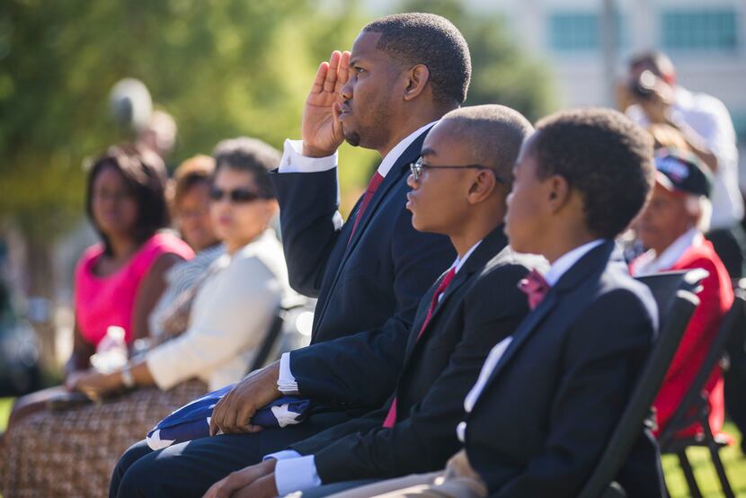 Calvin J. Spann II salutes during funeral services for Spann's father, retired Army Air...
