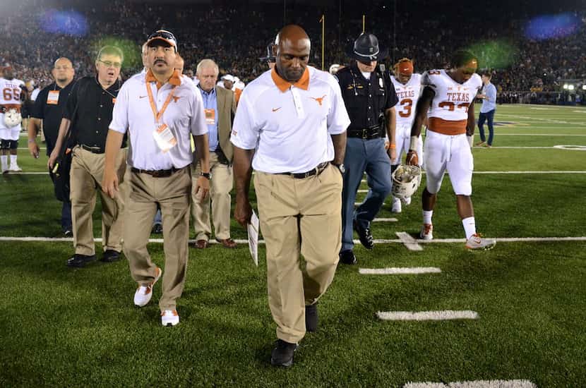 Texas coach Charlie Strong walks off the field after Texas' 38-3 loss to Notre Dame in an...