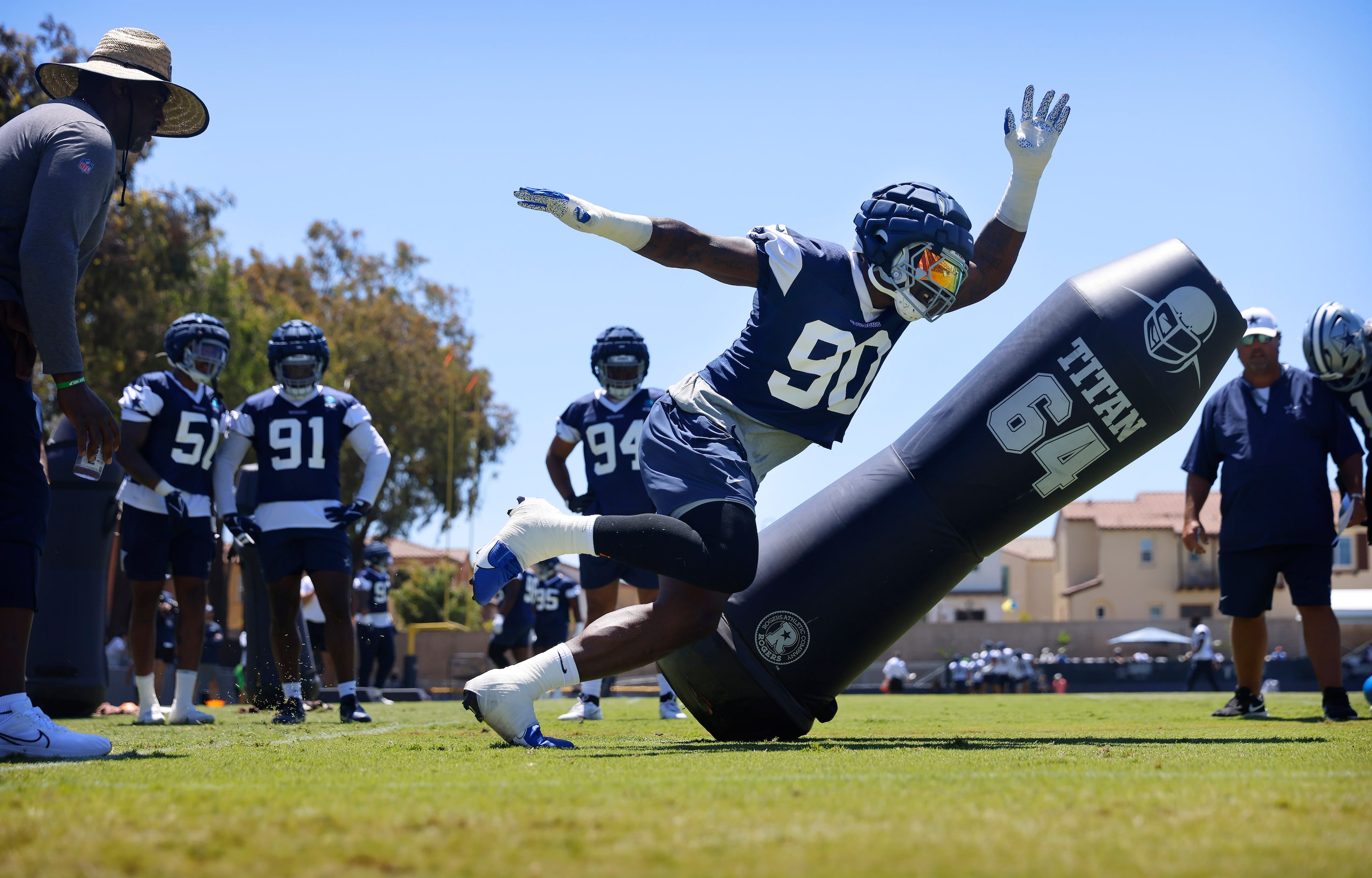 Dallas Cowboys defensive end DeMarcus Lawrence (90) turns the corner on a blocking dummy...