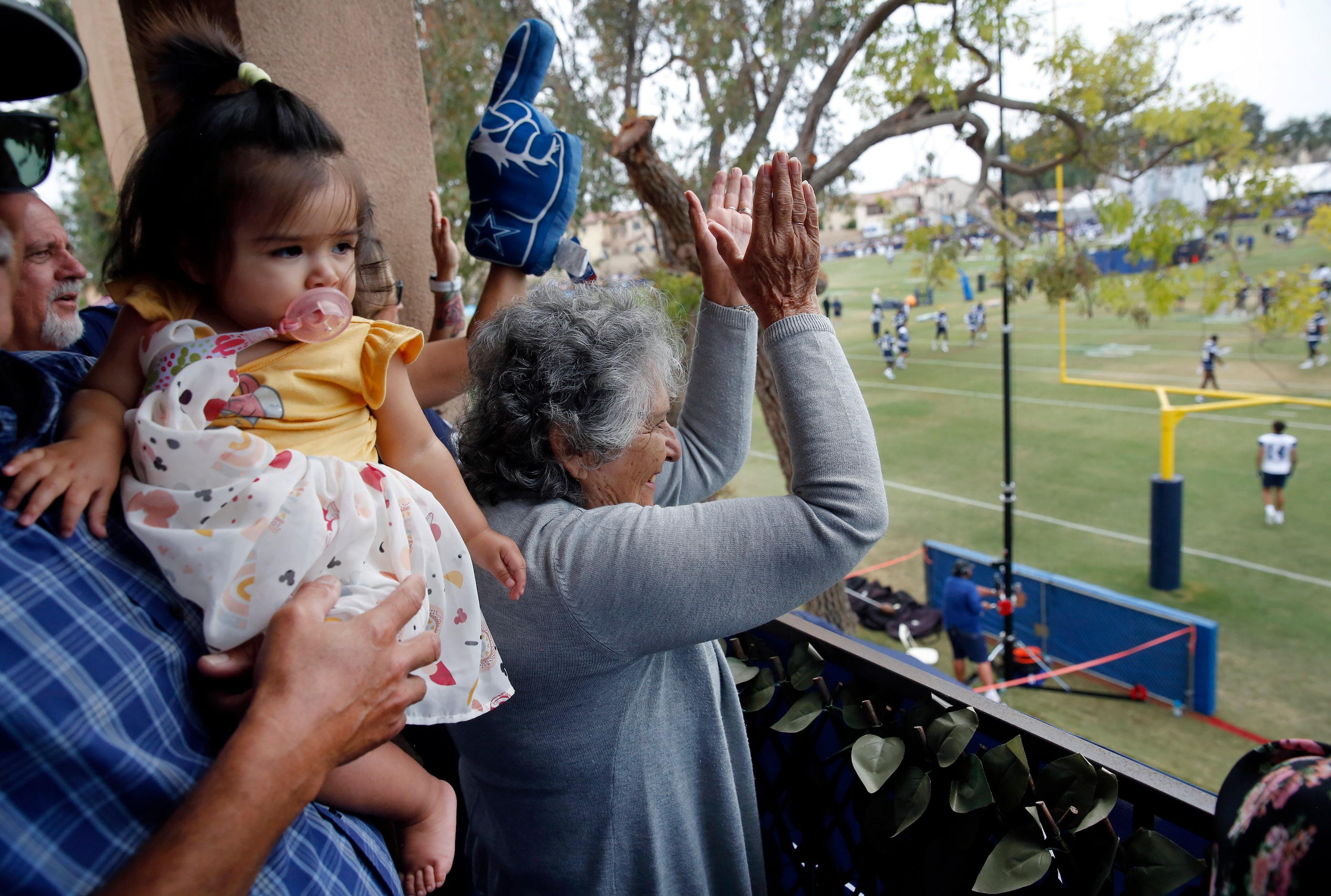 Robert Acosta (left) holds his 10-month old granddaughter, Nala, as Robert's mother, Adela...