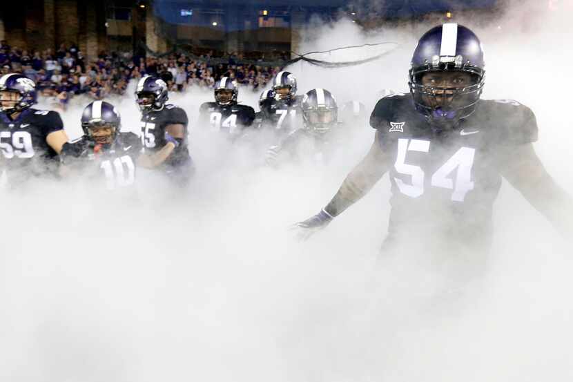 TCU Horned Frogs defensive tackle Joseph Broadnax Jr. (54) and his teammates race through...