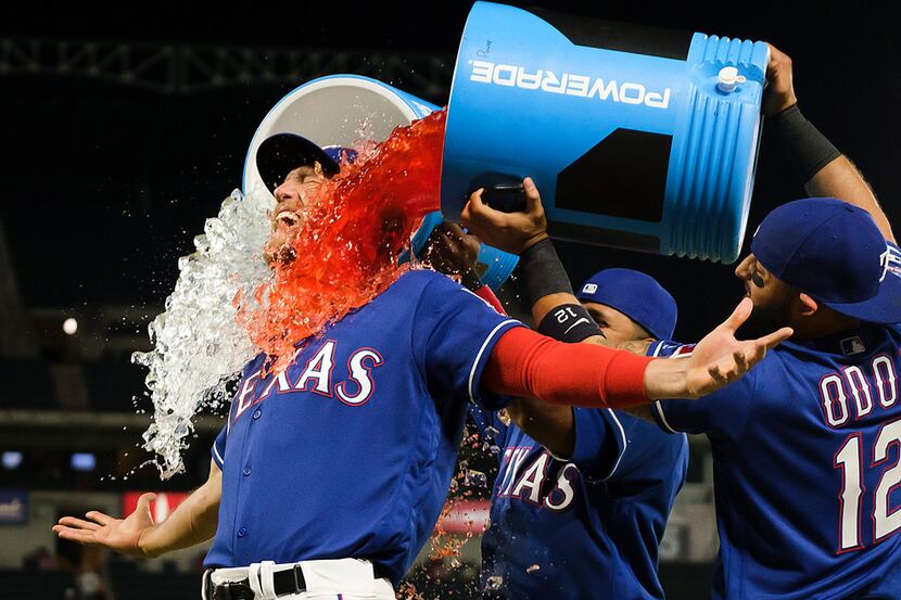 Texas Rangers outfielder Hunter Pence is doused with Powerade by shortstop Elvis Andrus and...