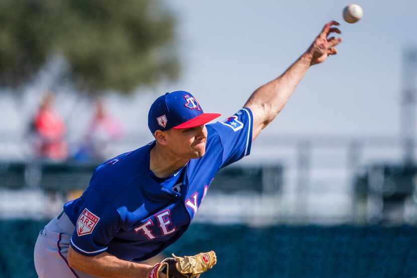 Texas Rangers pitcher Brock Burke pitches during the sixth inning of a spring training...