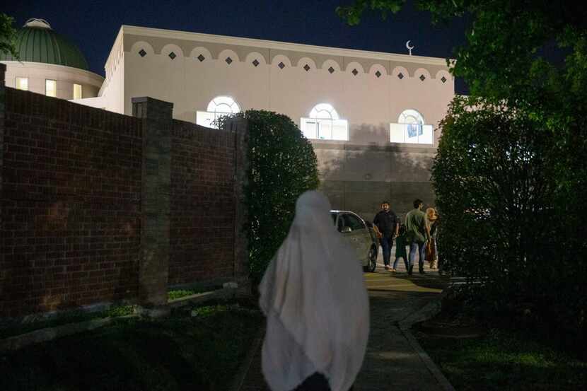 In this file photo, mosque-goers make their way for evening prayers after breaking their...