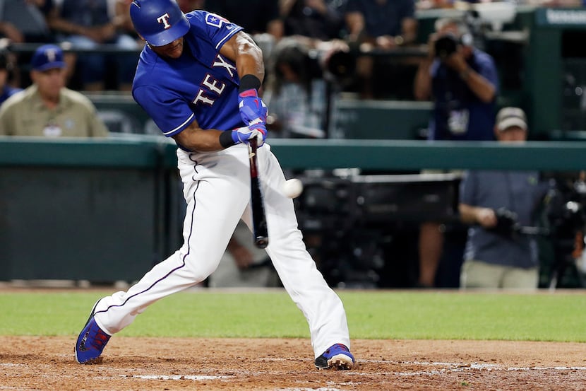 Texas Rangers' Adrian Beltre (29) makes contact for an RBI single during the sixth inning of...