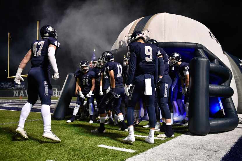 Liberty Christian gets pumped up before their game against Bishop Dunne at Warrior Stadium,...