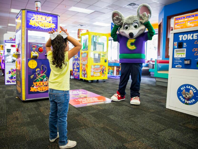 
Chuck E Cheese dances with Alyssa Martinez, 4, of Irving, Texas at Chuck E Cheese on...