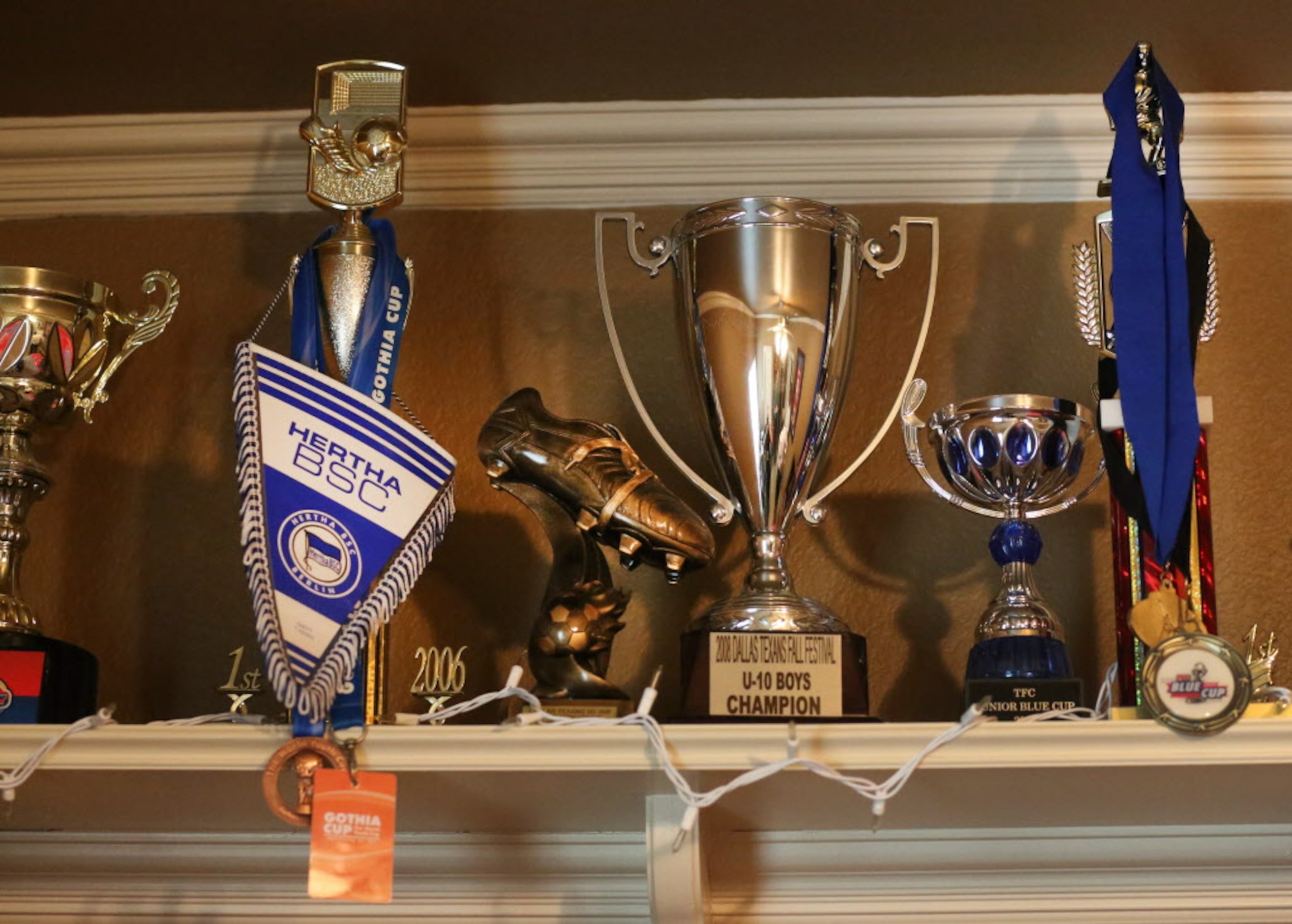 Some of Paxton Pomykal's many soccer trophies are on display in his bedroom at his home in...