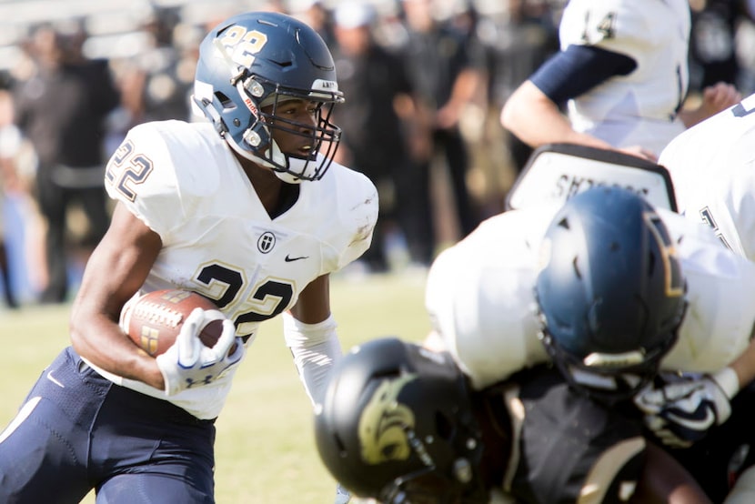 Jesuit running back E.J. Smith (22) rushes through the line during the Prep Showcase matchup...