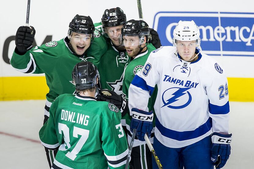 Tampa Bay Lightning defenseman Slater Koekkoek (29) gets caught up in the celebration as...