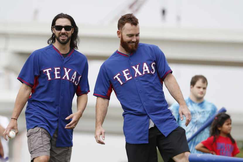 Texas Rangers pitchers Tony Barnette (left) and Sam Dyson speak during a free Play Ball...