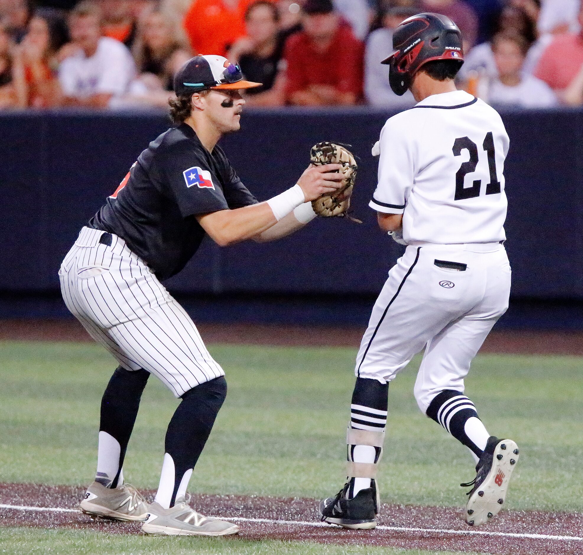 Rockwall first baseman Mac Rose (6) tags out Heath left fielder Zach Rike (21) in the...