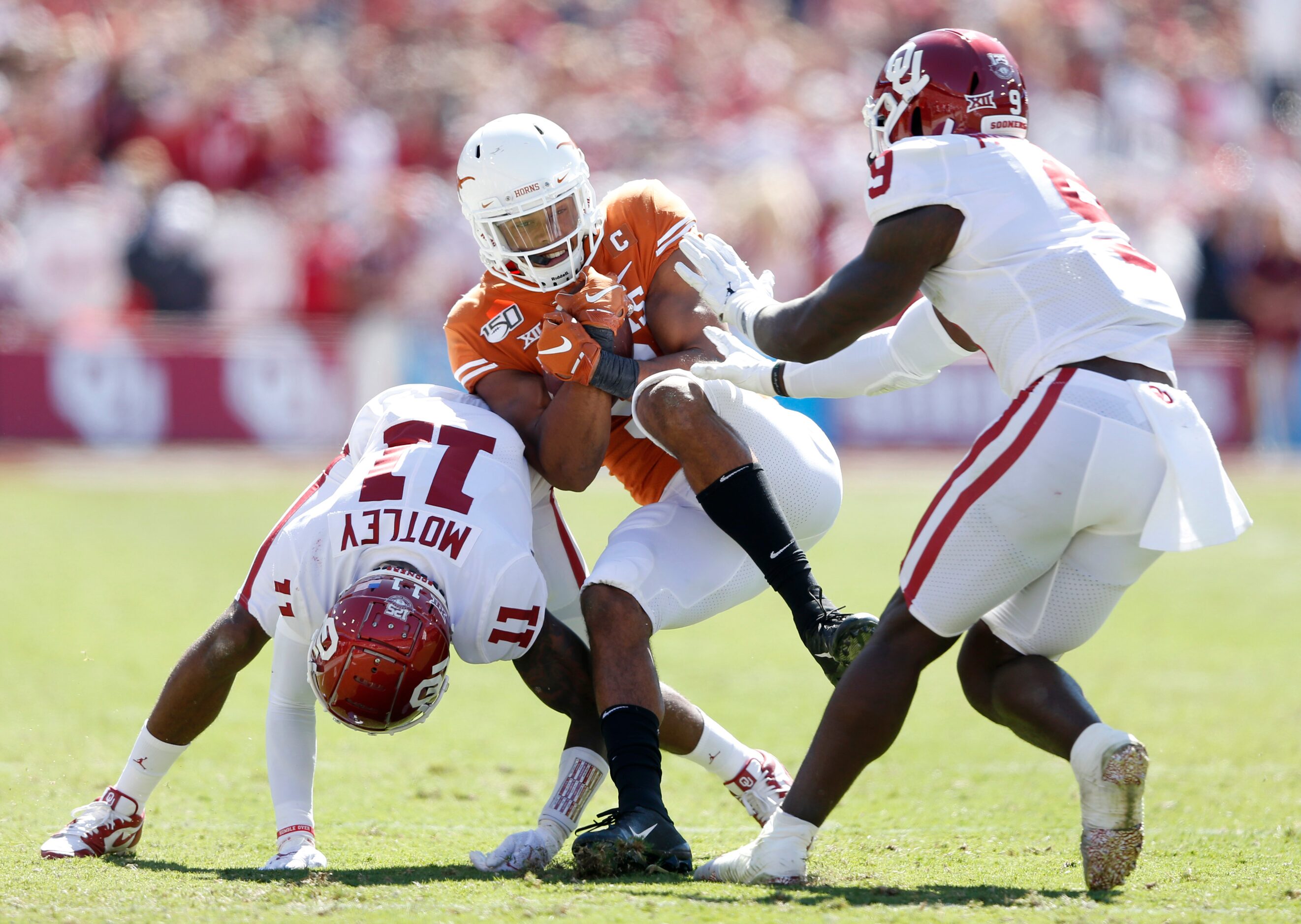 Texas Longhorns wide receiver Collin Johnson (9) is hit by Oklahoma Sooners cornerback...