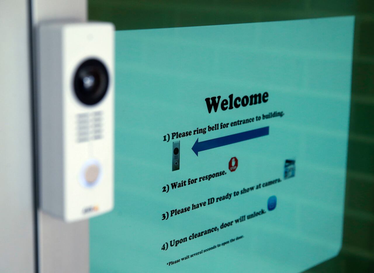 Visitors will have to ring a doorbell and wait outside for the front office to verify their...