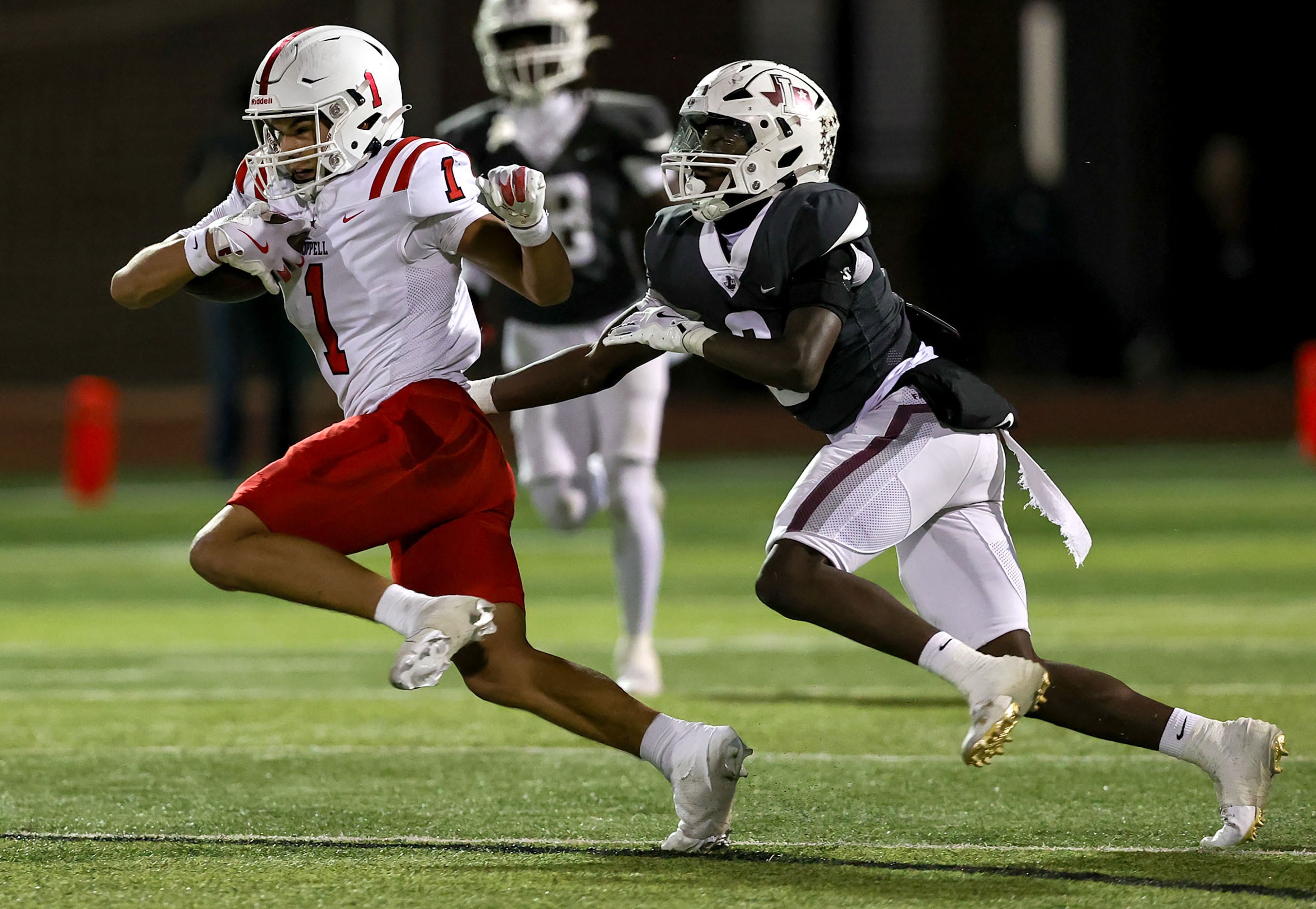 Coppell wide receiver Tucker Cusano (1) tries to fight off Lewisville linebacker Devin...