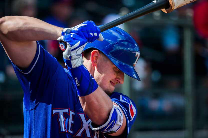Texas Rangers left fielder Ryan Rua (16) warms up before batting during the second inning of...