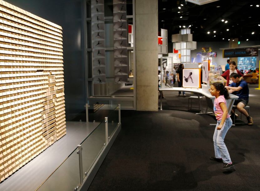 Sylvia Rodriguez, 9, of Spring plays with an interactive exhibit at the Perot Museum of...