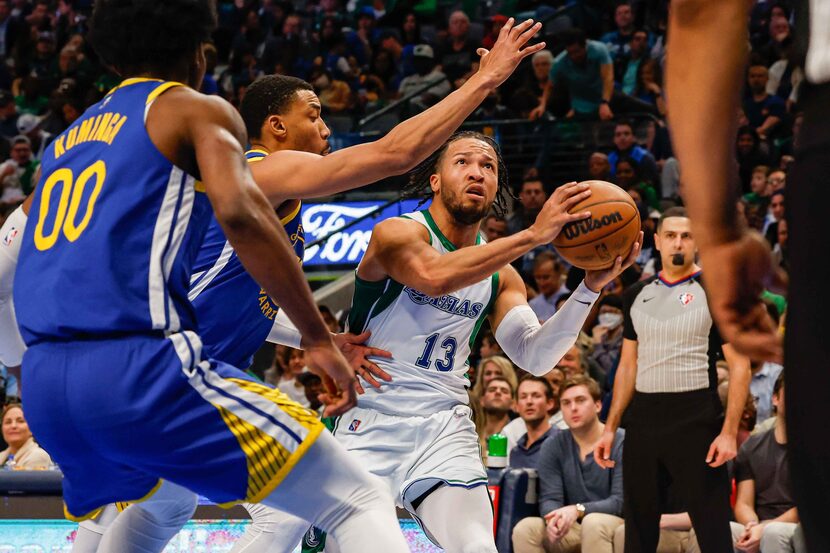 Dallas Mavericks guard Jalen Brunson (13) goes for a shot as Golden State Warriors forward...