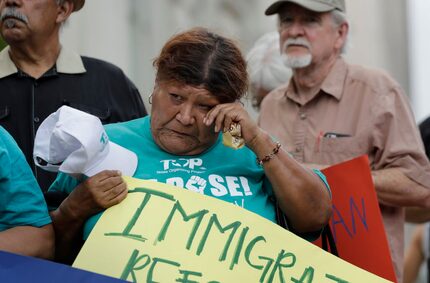 Eldia Contreras wipes away a tear as she takes part in a vigil at San Fernando Cathedral for...