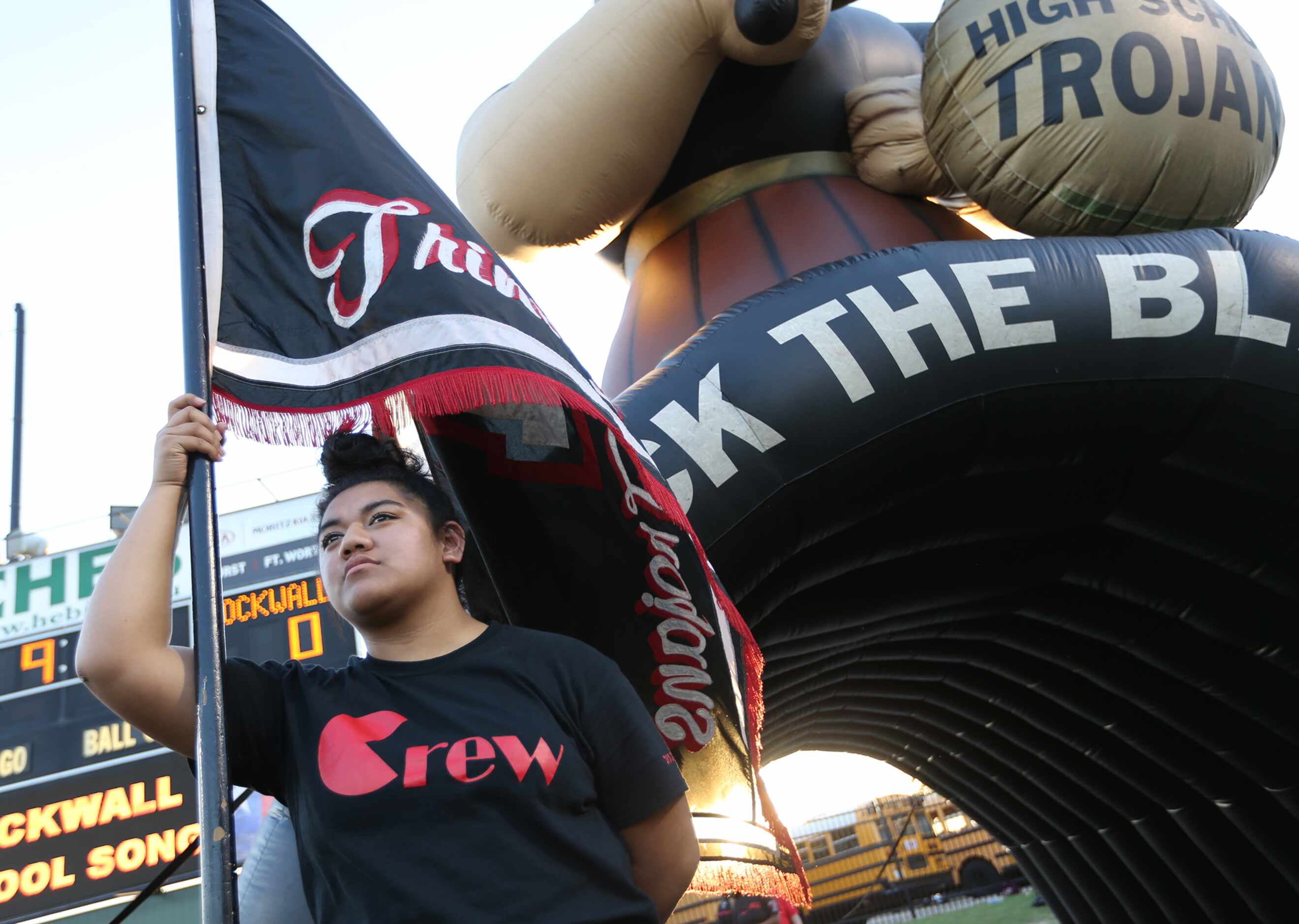 Trinity senior Nina Latu, cq, hold the schools flag prior to game action between Euless...