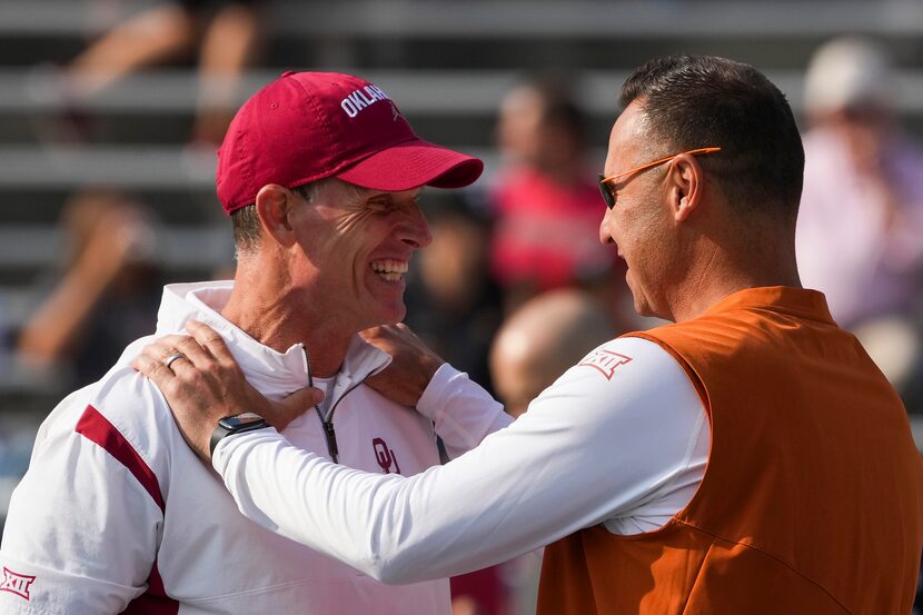 Texas head coach Steve Sarkisian (right) talks with Oklahoma head coach Brent Venables...