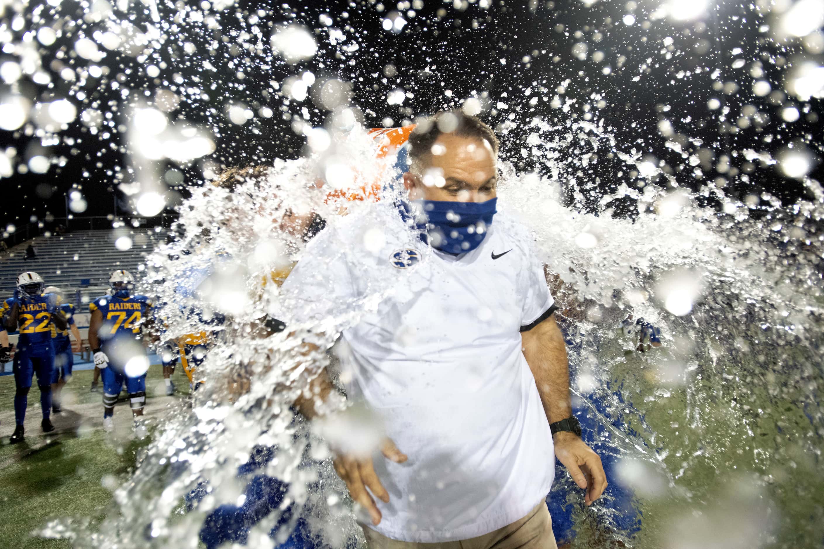 Sunnyvale head coach John Settle receives a celebratory dousing after his team beat Ferris...