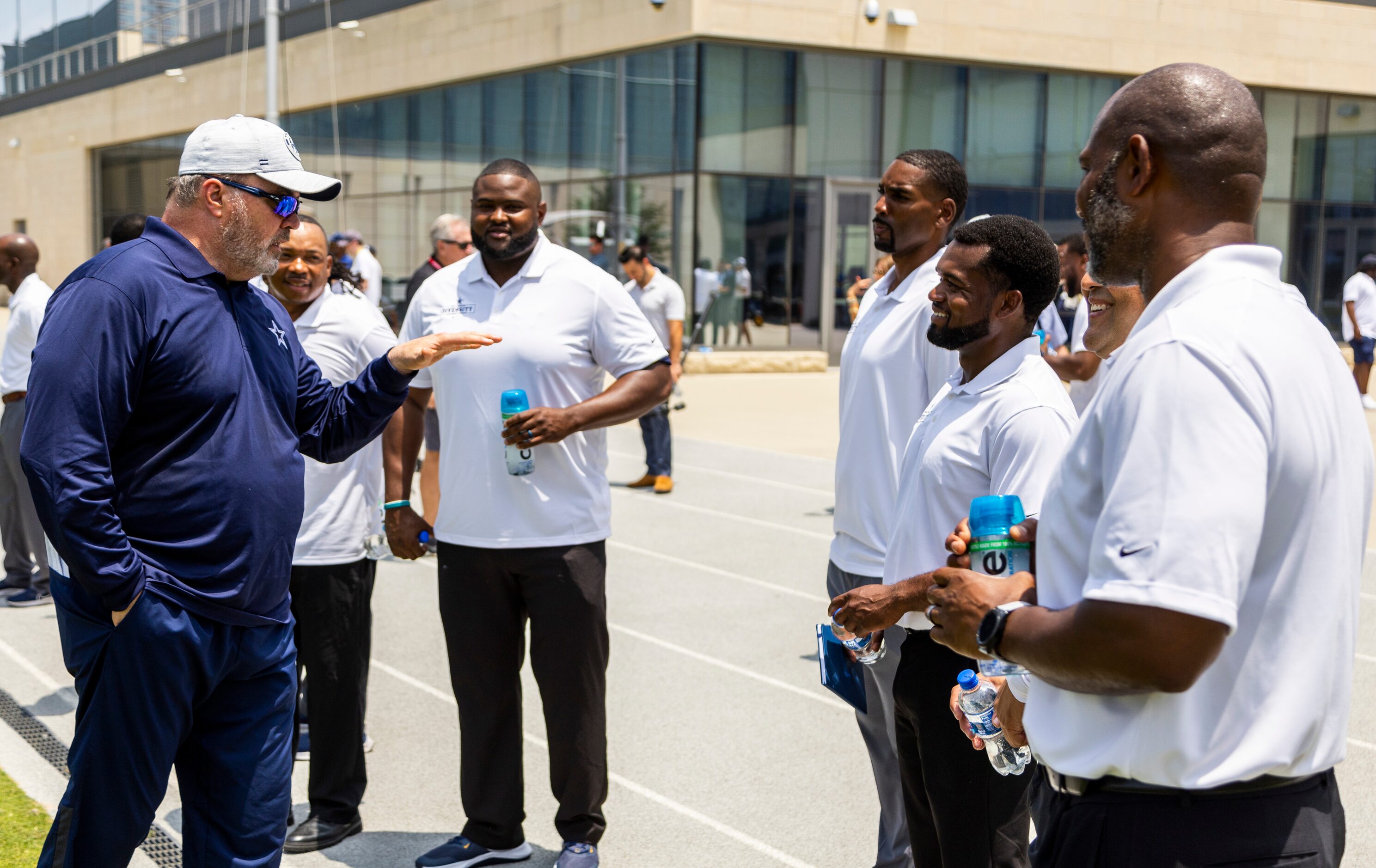 Dallas Cowboys head coach Mike McCarthy, left, speaks with Texas high school football...