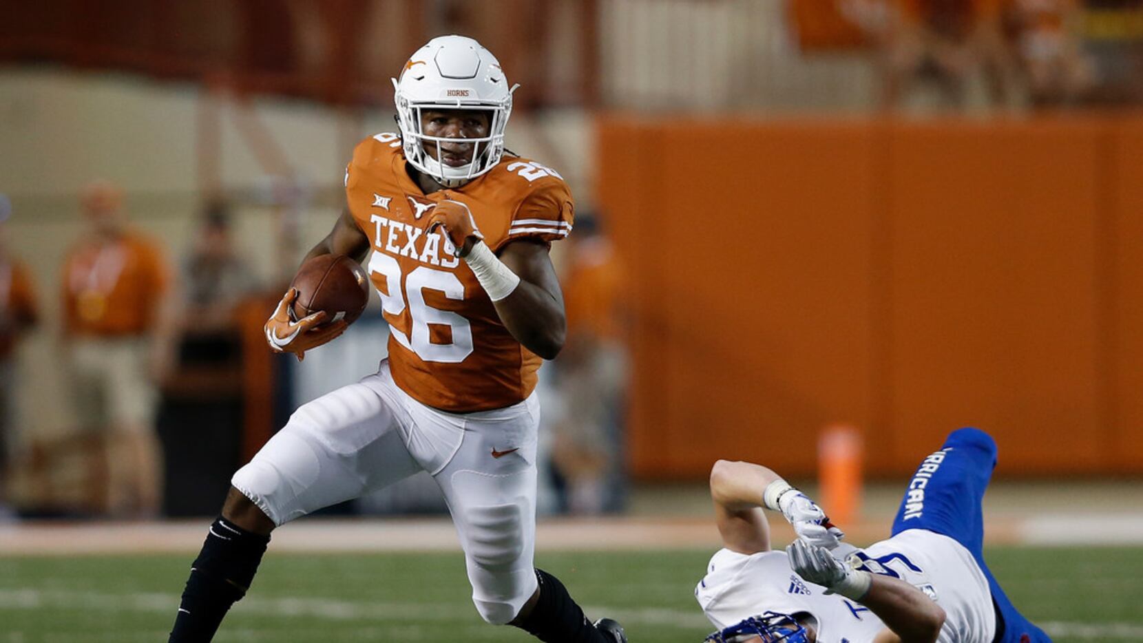 Texas running back Keaontay Ingram  breaks a tackle against Tulsa last season. He suffered a...
