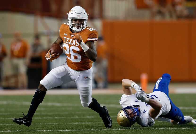 AUSTIN, TX - SEPTEMBER 08:  Keaontay Ingram #26 of the Texas Longhorns breaks a tackle by...