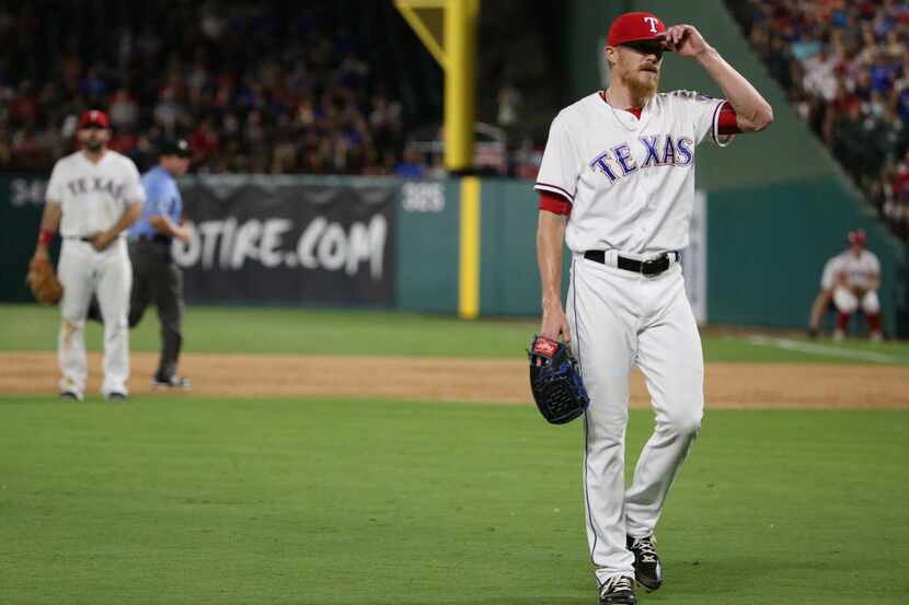Texas Rangers relief pitcher Jake Diekman (41) reacts after gives up a run on a sacrifice...
