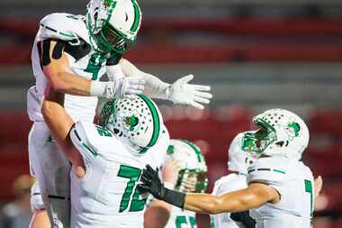 Southlake Carroll running back TJ McDaniel (4) is lifted up by offensive lineman Jackson...