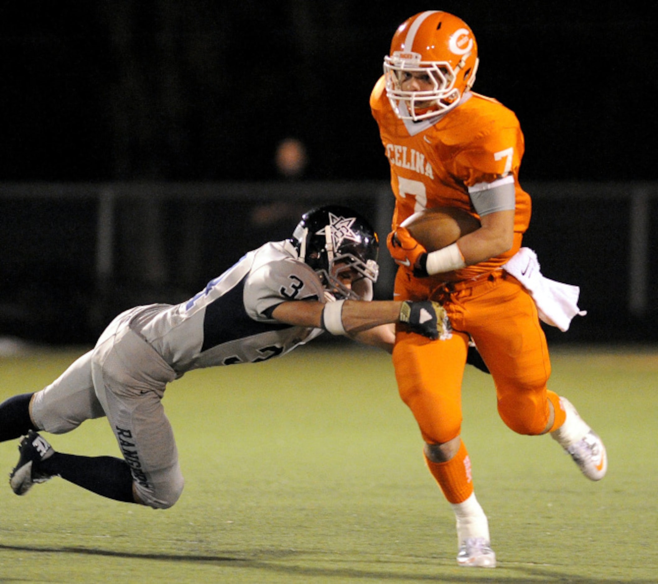 Celina's Cash Conder (7) runs through a tackle attempt by Frisco Lone Star's Brad Over (34)...