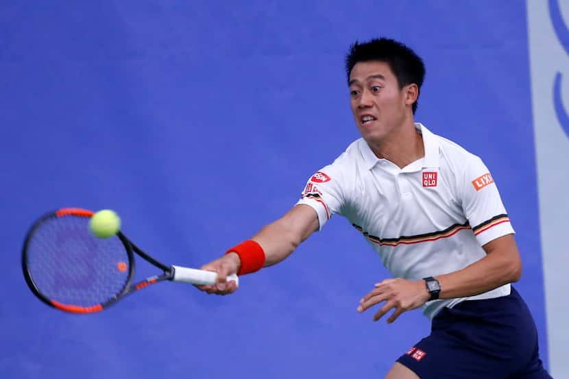 Kei Nishikori returns a serve by Dennis Novikov during a match in the round of 36 at RBC...