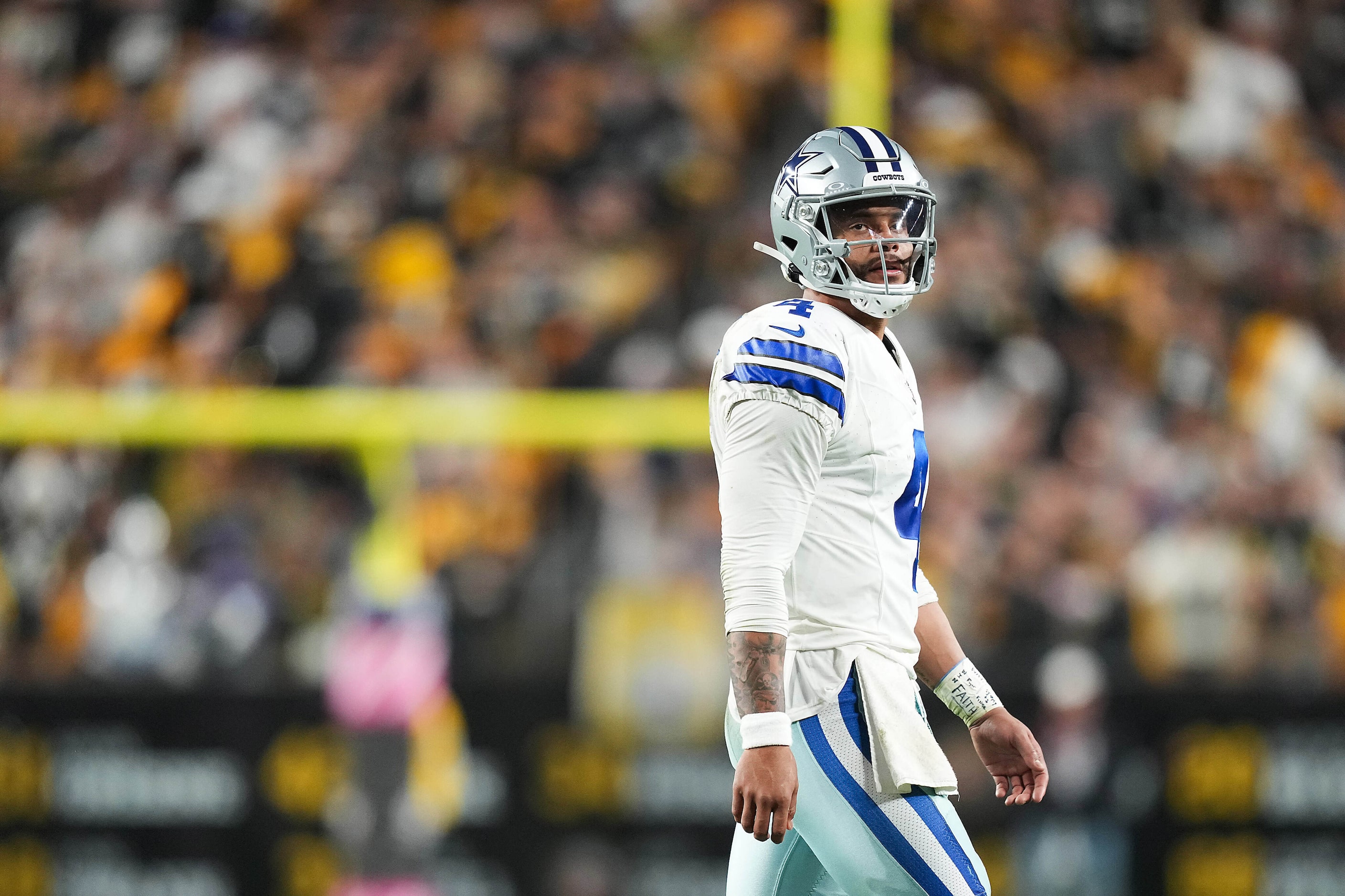 Dallas Cowboys quarterback Dak Prescott (4) heads to the bench after throwing an...