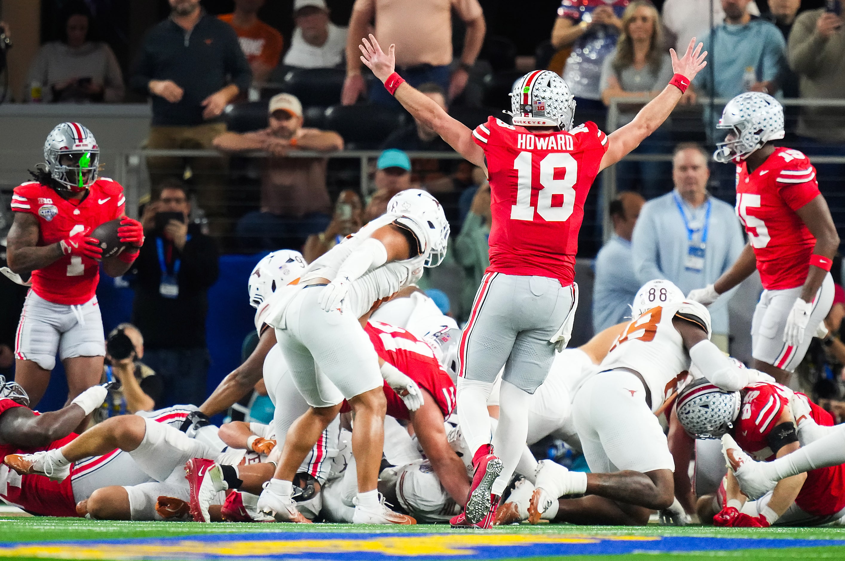 Ohio State quarterback Will Howard (18) celebrates after a touchdown run by running back...