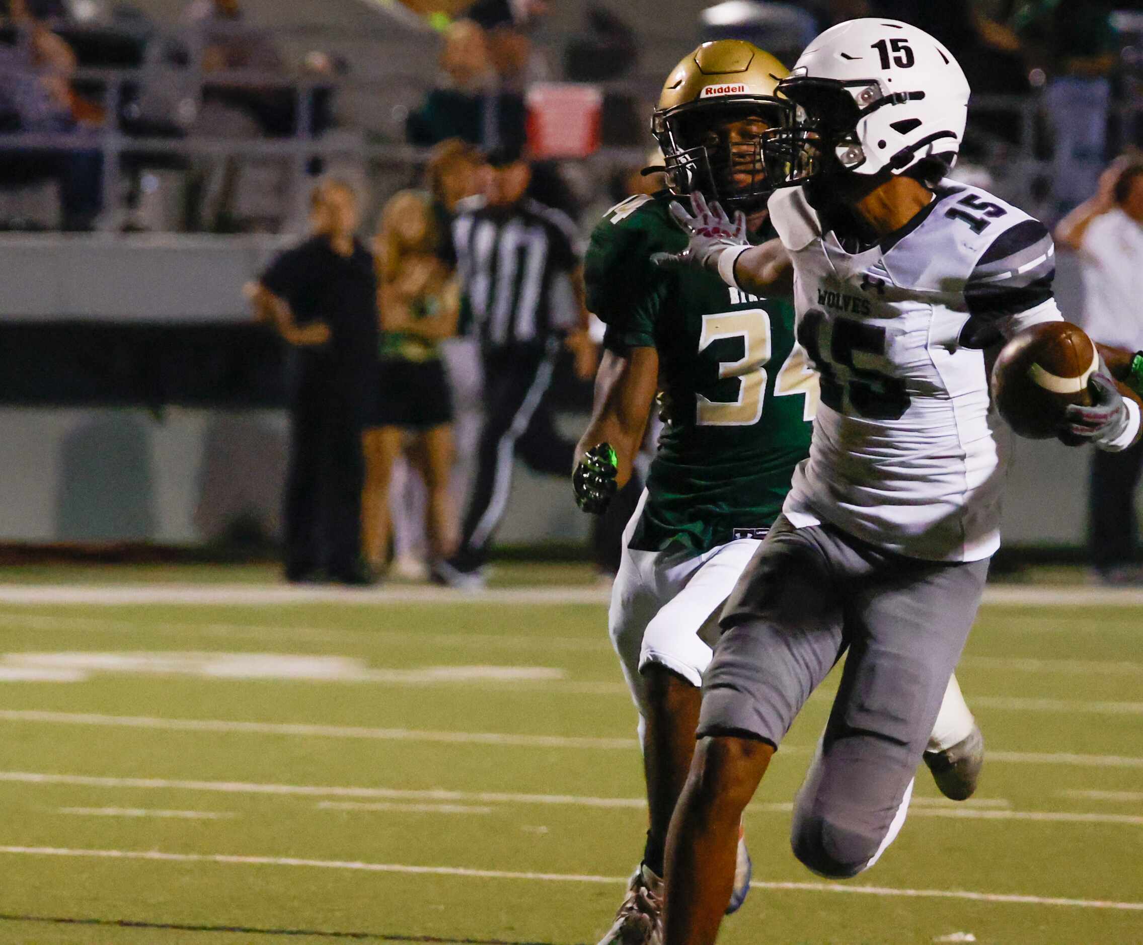 Mansfield Timberview wide receiver Titus Evans (15) looks back at Birdville defensive back...