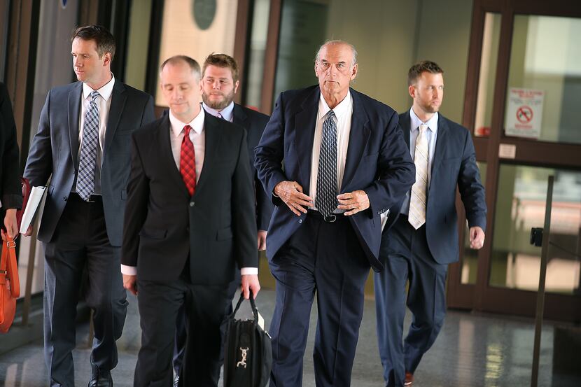 Former Minnesota Governor Jesse Ventura, second from right, makes his way out of the Warren...