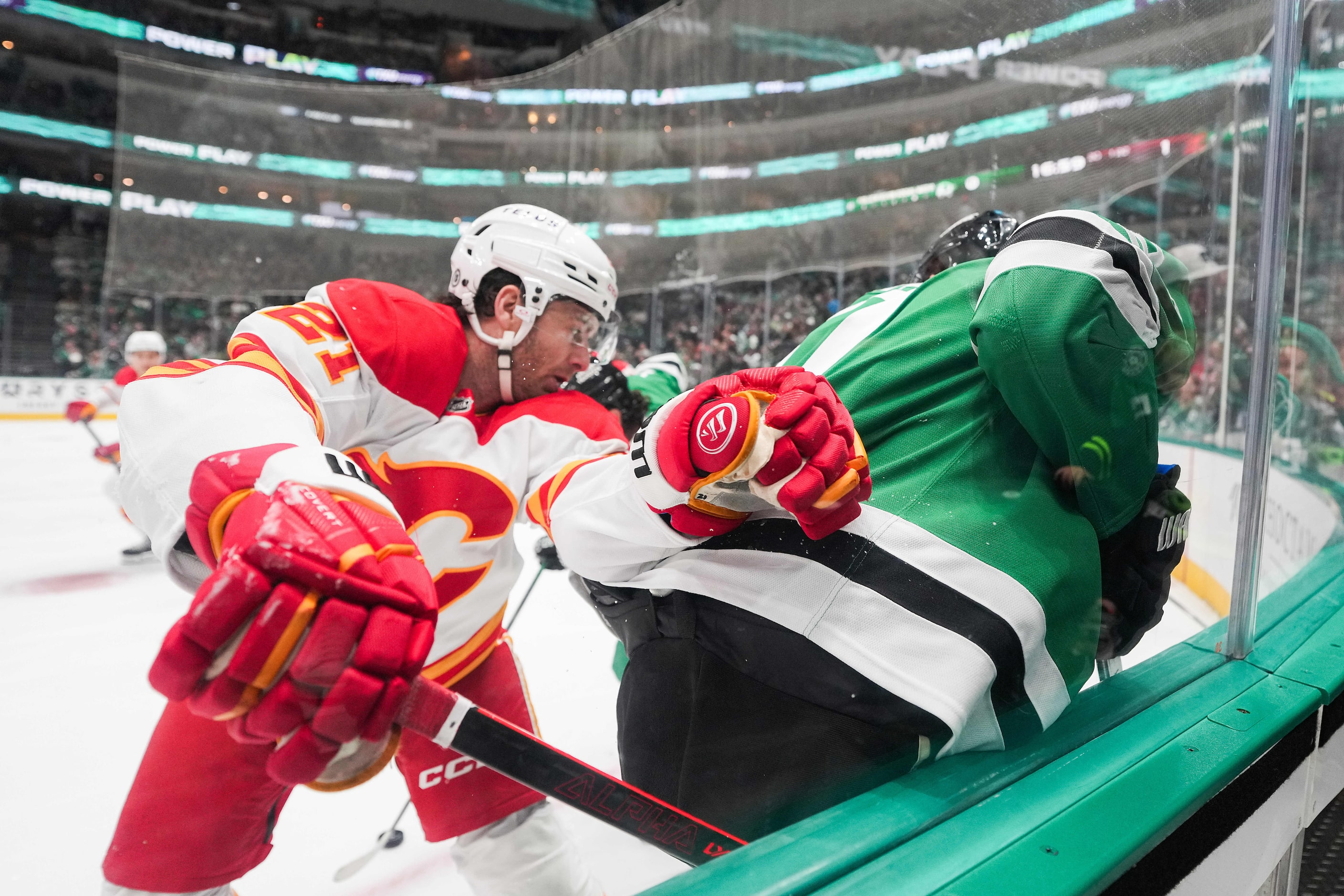 Calgary Flames center Kevin Rooney (21) fights for the puck with Dallas Stars left wing...