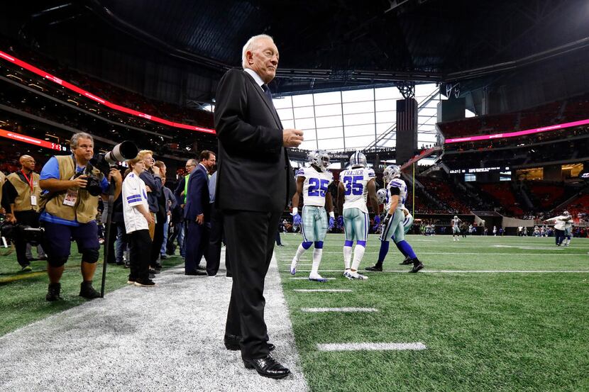 Dallas Cowboys owner Jerry Jones watches the Atlanta Falcons warm up before his team faces...