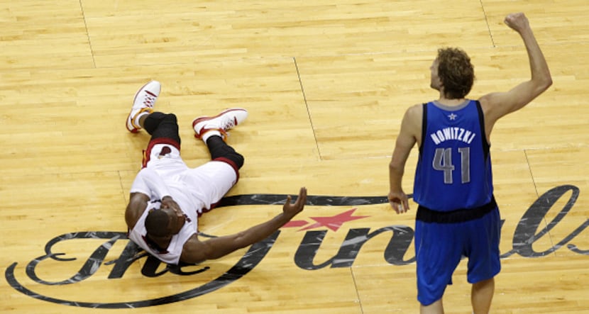 Miami Heat shooting guard Dwyane Wade (3) lays on the floor and looks up at  Dallas...