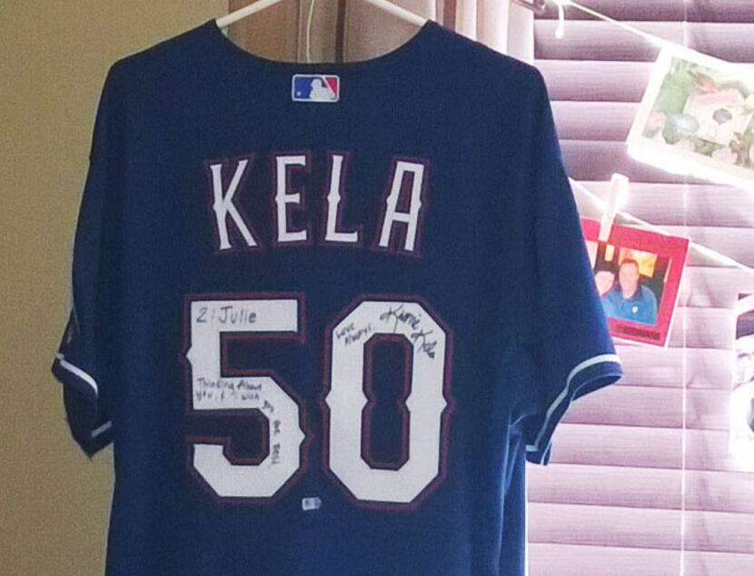 a signed Keone Kela road jersey that was presented to the three children of Texas Rangers...