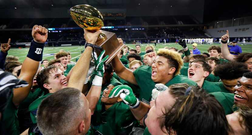 The Frisco Reedy Lions football team celebrates their win over Midlothian with the Class 5A...